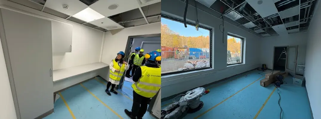 En gruppe mennesker i gule vester i et rom med stor skjerm